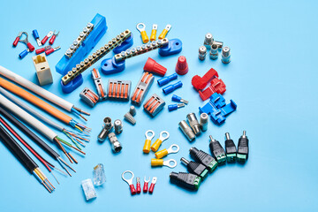 Different electrical tools isolated on blue background, electrician equipment, wires, terminals, connectors, fuses, switches