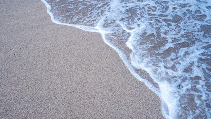 Fototapeta na wymiar Daytime white sand beach with lovely tiny waves