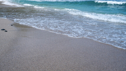 white sand beach and small waves from the blue sea