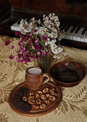 Still life of delicious sweet cookies with milk, flowers and nuts.