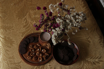 Obraz na płótnie Canvas Still life of delicious sweet cookies with milk, flowers and nuts.