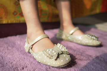child feet with sandal on a floor mat at early morning 