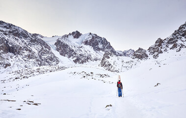 Fototapeta na wymiar Skier climb at high snowy mountains