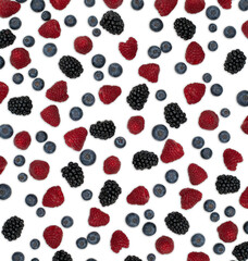 Berries pattern isolated on white. Strawberries, raspberries blackberries and blueberries arranged on white. Top view.