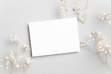 Blank minimalistic card mockup with botanical decoration, top view with copy space