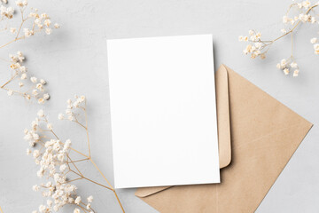 Invitation or greeting card mockup with dry gypsophila, blank card with botanical decoration