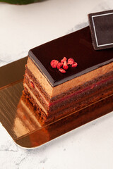 Chocolate sponge cake with mousse, raspberry confit, glaze and candied berries