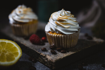 chocolate cupcake with icing on a wood board