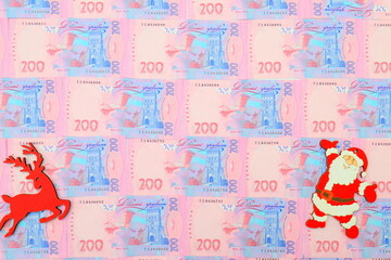 Ukrainian hryvnia, 200 hryvnias. Money background, Ukraine money. Christmas New Year background with Toy santa claus and deer