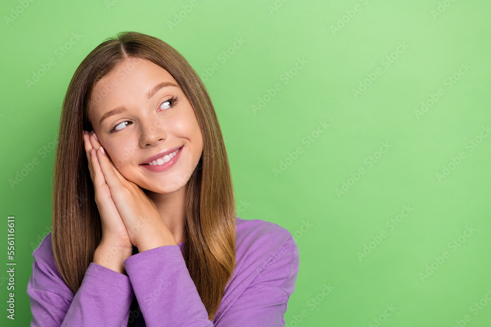 Sticker Portrait of optimistic girl long hairstyle purple long sleeve arms on cheekbones look empty space isolated on green color background