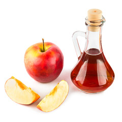 Vinegar in a jug and ripe apples isolated on a white.