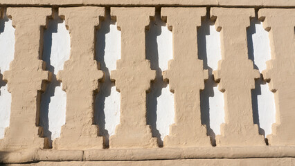 Adornos geométricos en pared de yeso blanco y beige