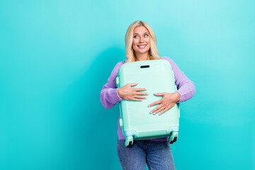 Photo of positive nice person hands hold suitcase look empty space isolated on teal color background