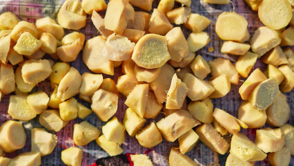 Ginger or adrak known as (Zingiber officinale). Ginger roots peeled with knife over chopping block. Top view