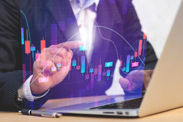 professional stock market trader analysing company chart candlestick on digital screen, concept of trading investing money and research stock share price.