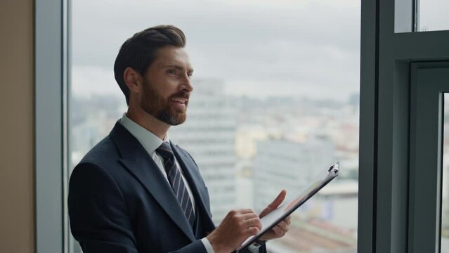 Manager satisfied financial documents at office window closeup reading statistic