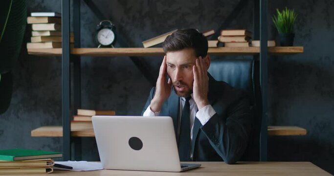 Shocked man entrepreneur upset with bad deal, looking at laptop screen, reaction on crisis. Unpleasantly surprised business man by bad email seen on computer while working at office. Problems at work