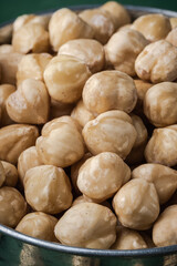 A pile of peeled hazelnuts as a textured background. Healthy nutrition concept