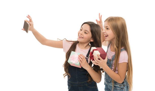 A private selfie shooting. Adorable little girls taking birthday selfie. Pretty small children making photograph with selfie camera on smartphone. Selfie is now a part of modern life