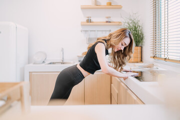 happy woman doing push up kitchen. smiling determined healthy concept woman control exercising flexible body to build muscle. beautiful woman training energy build muscle using body balance technique