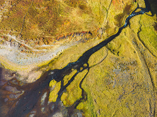 Aerial view of river running down into a small waterfall - Iceland, autumn 2022
