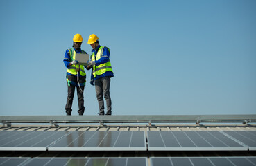 Both of Engineer in charge of solar panel installation The installation of solar energy conversion into electricity for a warehouse is currently being investigated.