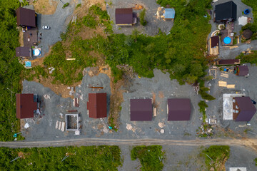 Fototapeta na wymiar Stages of construction houses wood build roof. Slab in and framework has been erected, aerial top view