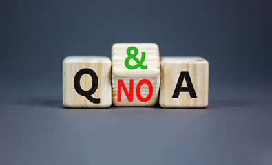 Q and A question and answer symbol. Concept word Q and A or Q no A on wooden cubes. Beautiful grey table grey background. Business Q and A question and answer concept. Copy space.