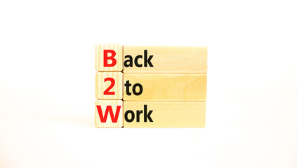 B2W back to work symbol. Concept words B2W back to work on wooden blocks on a beautiful white table white background. Business and B2W back to work concept. Copy space.