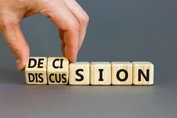 Discussion and decision symbol. Concept word Discussion and Decision on wooden cubes. Businessman hand. Beautiful grey table grey background. Business discussion and decision concept. Copy space.