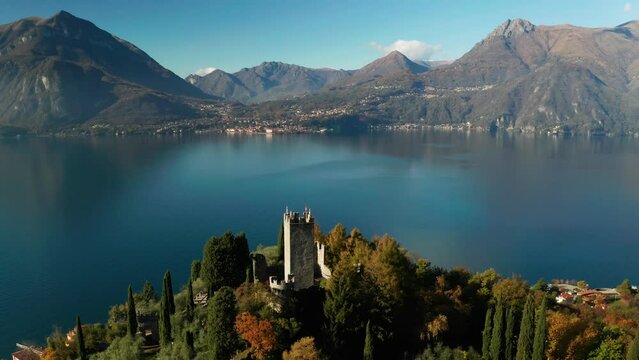 Scenic aerial view of Vezio Castle, above the Varenna town, at the center of Lake Como in northern Italy. Vezio castle is an ancient military outpost of early medieval origin