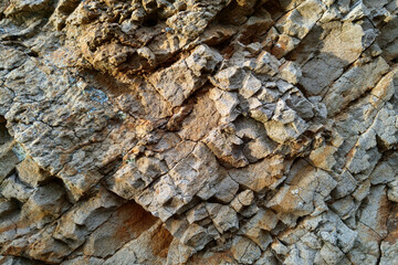 The background of the rocky rock of the mountain. The texture of stone, minerals.