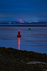Marker buoys at dusk in the mersey for ship navigation
