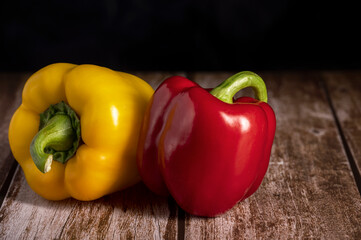 Red and yellow peppers lie on the table in the kitchen