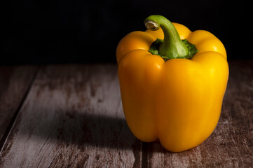 Yellow pepper lies on the table in the kitchen 