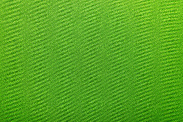 The texture of a dense green fabric. Background from fabric for tailoring. Canvas