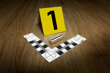Crime Scene Investigation - bullet casing as a piece of evidence placed with forensic ruler and...