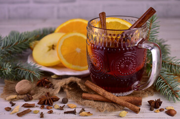 Christmas mulled wine with spices and fruits in a cup. Traditional hot drink for Christmas

