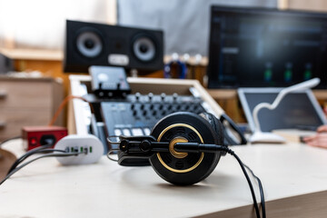 Old professional headphones on the table in the recording studio