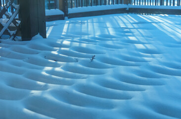 Drifting Snow on Backyard Deck During a Cold Winter Morning