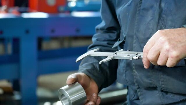 Close Up Of Worker Makes A Control Measurement of the part with a vernier caliper