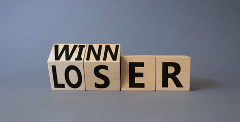 Winner and Loser symbol. Turned wooden cubes with words Winner and Loser. Beautiful grey background. Business and Winner and Loser concept. Copy space