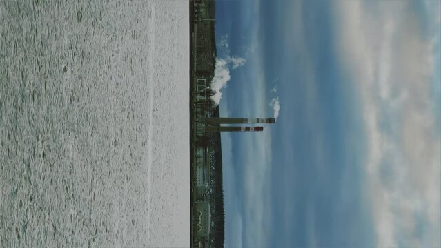 View of the tall chimneys of an industrial enterprise with a chimney polluting the atmosphere. The plant for the production of strategic intercontinental missiles "Topol-M". Russia, Votkinsk 2022