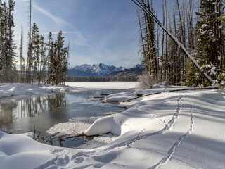 Sawtooth mountains in winter with lake and stream
