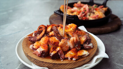 Appetizing beautiful dishes with seafood on the table in the restaurant. Octopus and shrimp ready to eat.
