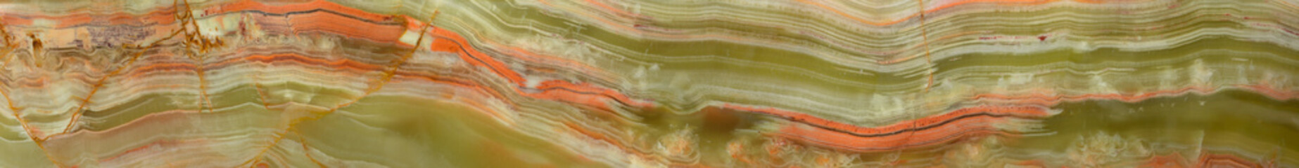Onyx texture. Green and orange streaks on semi-precious stone surface, variety of agate