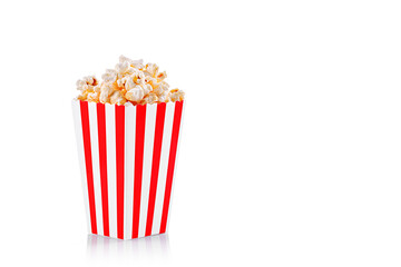 Glass with popcorn on a white background