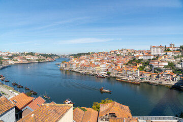 Douro river with the city of Porto on its banks and a historical ship sailing on the river Douro,...