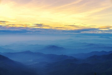 Fototapeta na wymiar cloudy sunrise in the mountains top 