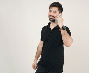 young asian man talking on mobile phone happily. smiling young boy in black clothes holding phone...